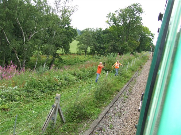 Photo:Trackside workers clearing away vegitation