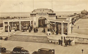 Photo:To Mum, This is a view postcard of the pier at Skeggy. It is at the end of Scarborough Ave, where my Billet is. You see the tobbaconist on the left with Players in the window? Well that is our hairdressers now! We do a lot of our drilling on the bit of pavement shown. We will have to do a guard on the pier shortly.